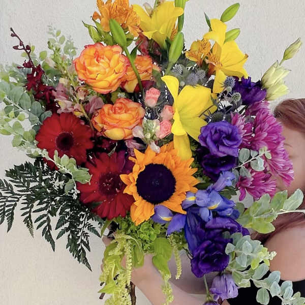 Colorful bouquet with sunflowers, roses, lilies, and gerbera daisies