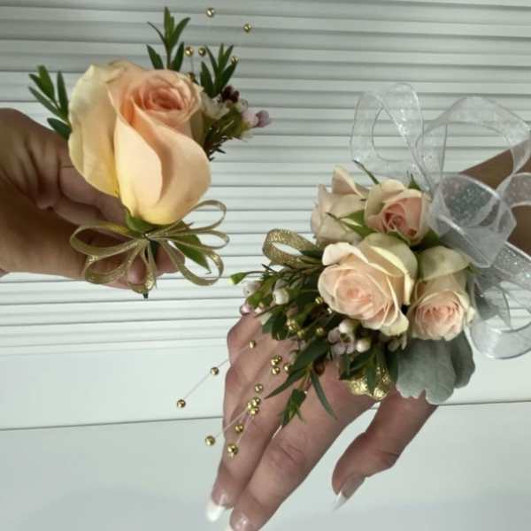 Two rose wrist corsages with ribbon bows and gold bead accents