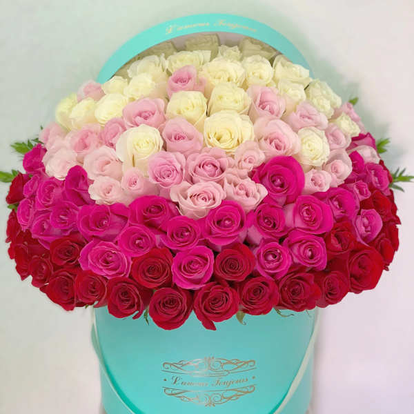Heart-shaped box filled with pink, white, and red roses