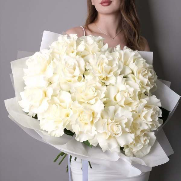 Large bouquet of white roses wrapped in white paper