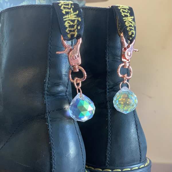 Pair of black platform boots with dangling crystal charms