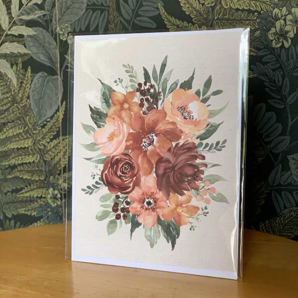 Floral greeting card with peach and burgundy flowers in a clear sleeve