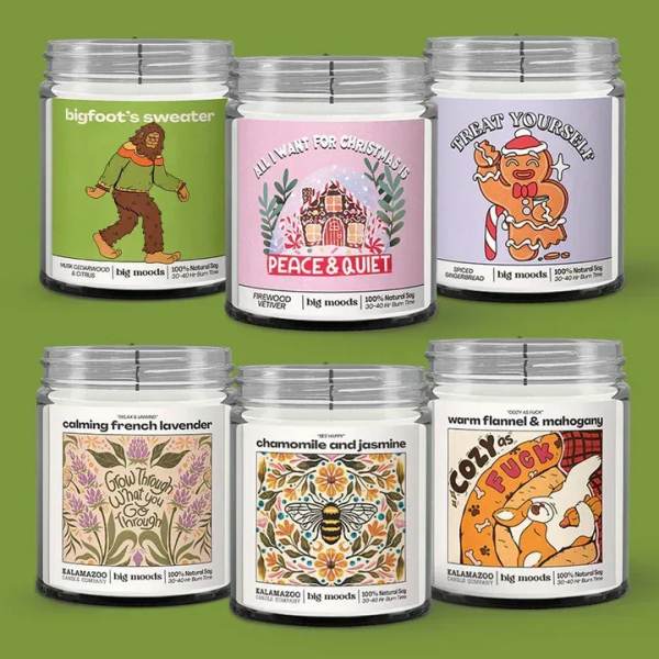 Six scented candles in glass jars with illustrated labels