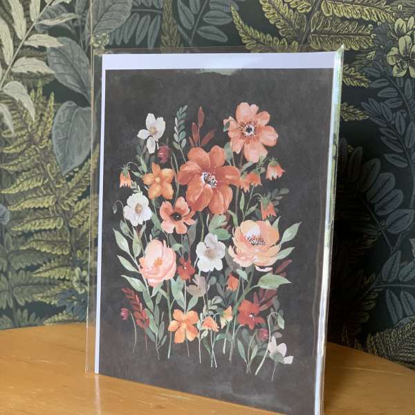 Floral greeting card with orange and white flowers on a dark background