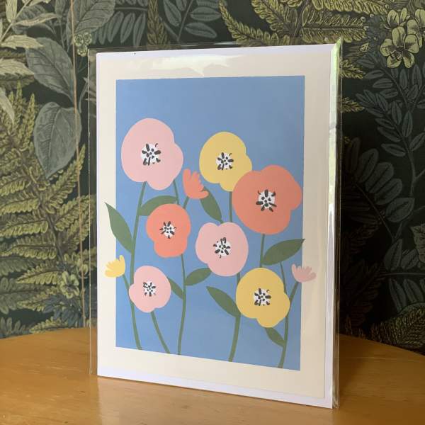 Greeting card with colorful stylized flowers in a clear sleeve
