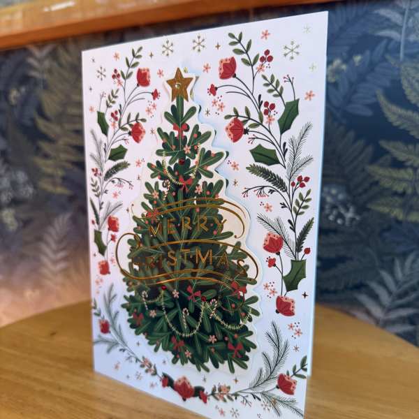 Christmas card with a decorated tree and floral border