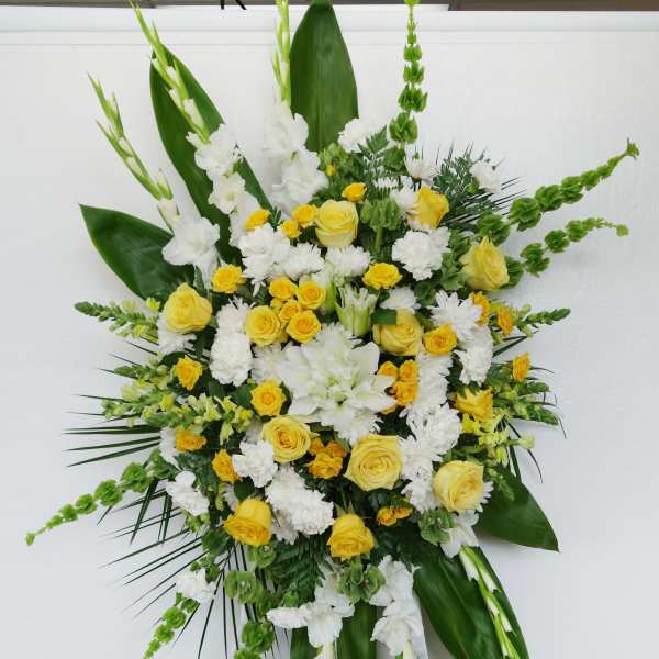 Standing floral spray with yellow and white flowers