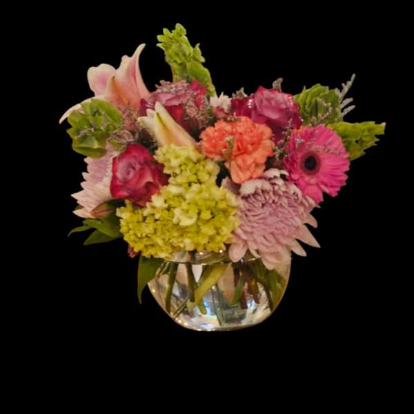Mixed pink and green flower arrangement in a clear glass vase