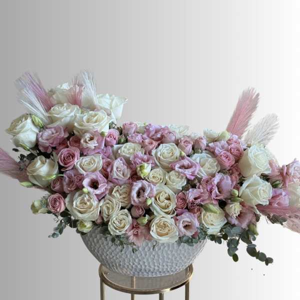 Large pastel rose arrangement in a textured white bowl