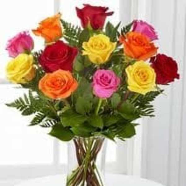 Bouquet of multicolored roses in a clear glass vase