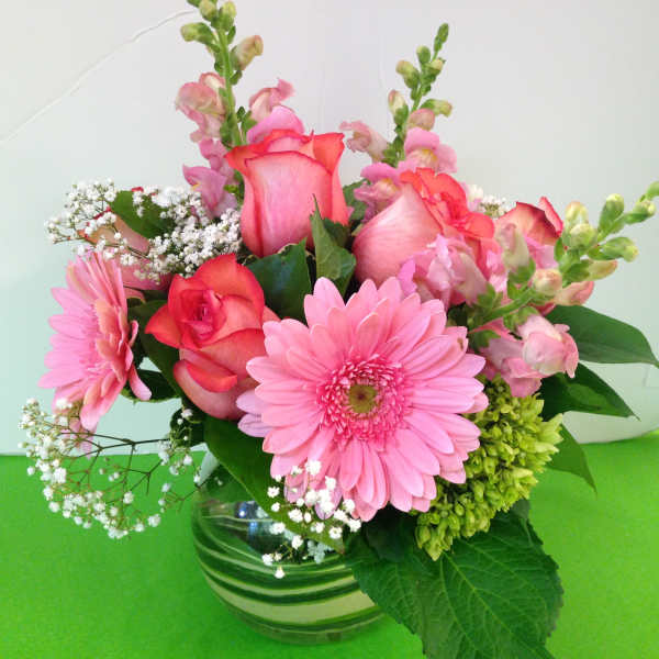 Pink roses and gerbera daisies in a glass vase
