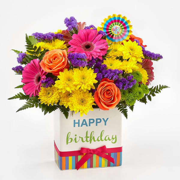 Bright mixed bouquet in a birthday gift box with a ribbon