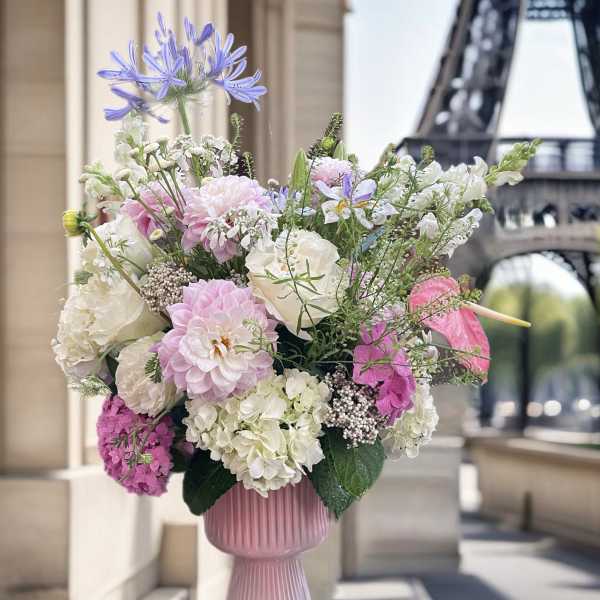 Pink and white floral arrangement in a ribbed vase