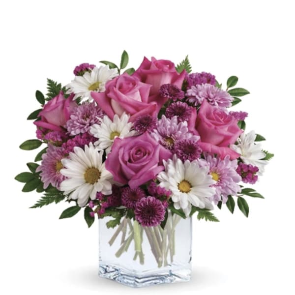 Pink roses and white daisies in a clear glass vase
