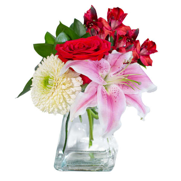Bouquet of red roses, pink lilies, and white chrysanthemum in a glass vase