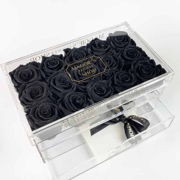 Black roses in a clear acrylic gift box with a drawer and ribbon