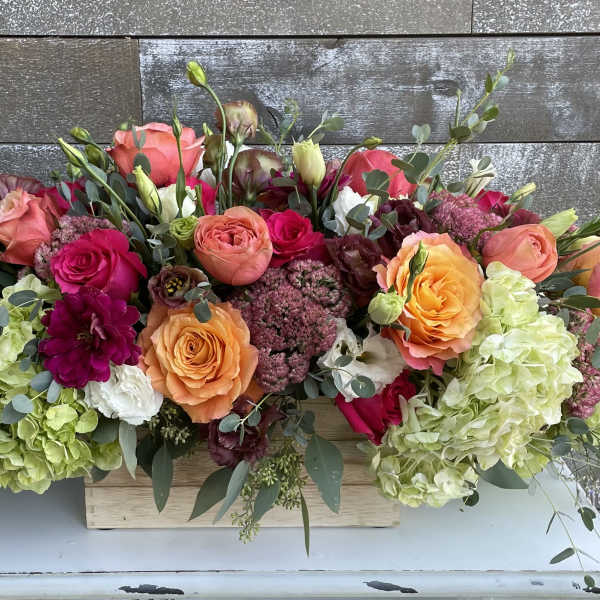 Mixed bouquet of roses and hydrangeas in a wooden box