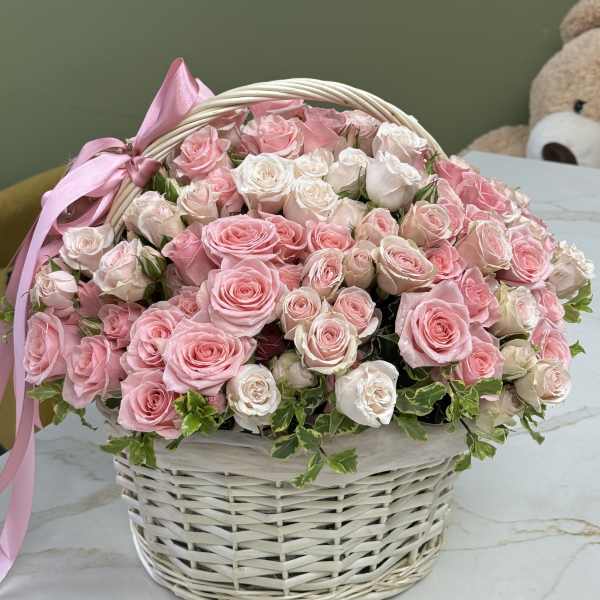 Basket of pink and white roses with a pink ribbon