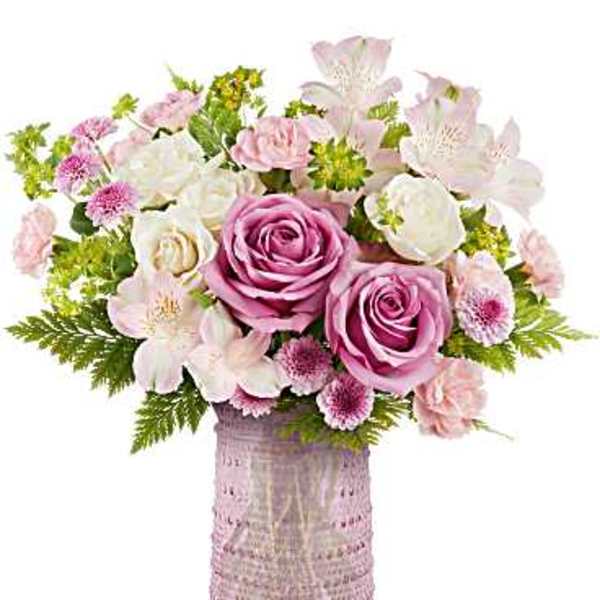 Pink and white flower arrangement in a textured vase