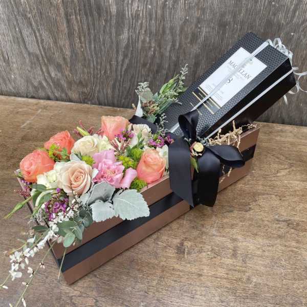 Rectangular gift box with pastel roses and a black ribbon