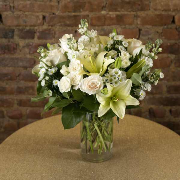 White floral arrangement in a clear glass vase