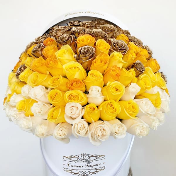 Bouquet of yellow, white, and bronze roses in a white hat box
