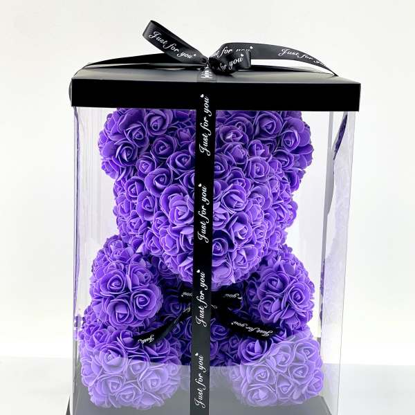 Purple rose teddy bear in a clear gift box with black ribbon