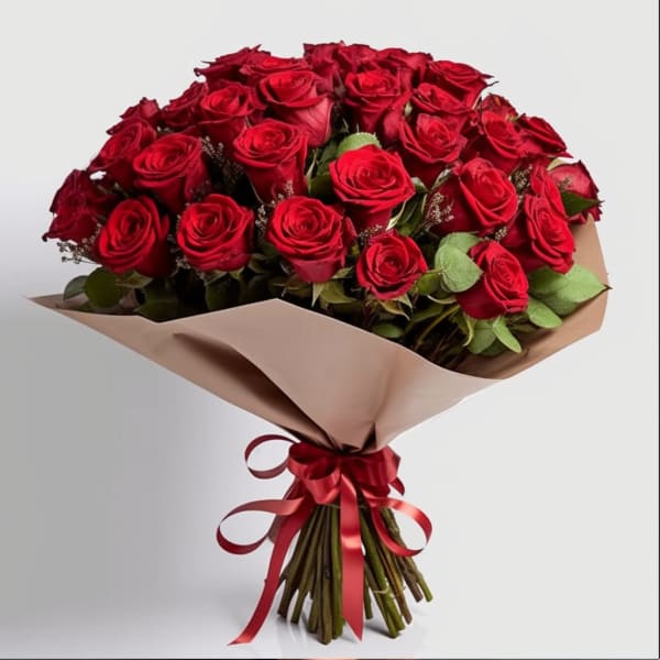 Bouquet of red roses wrapped in beige paper with a red ribbon