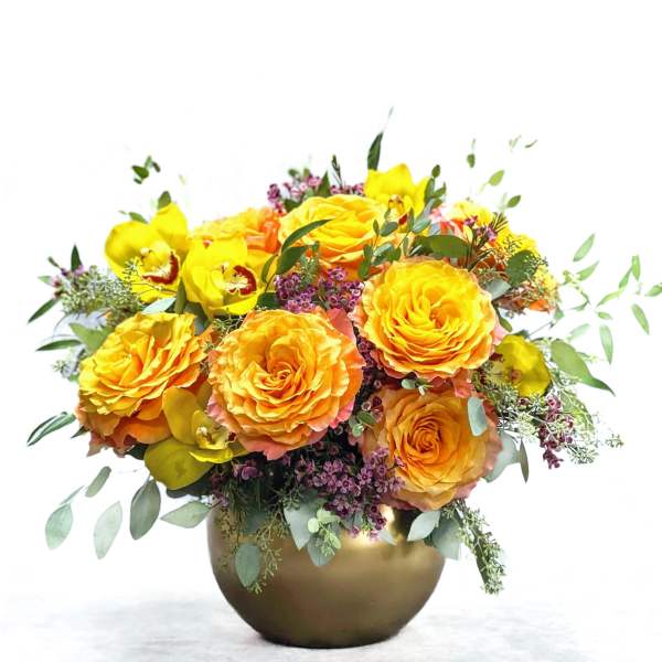 Yellow and orange rose bouquet in a gold vase