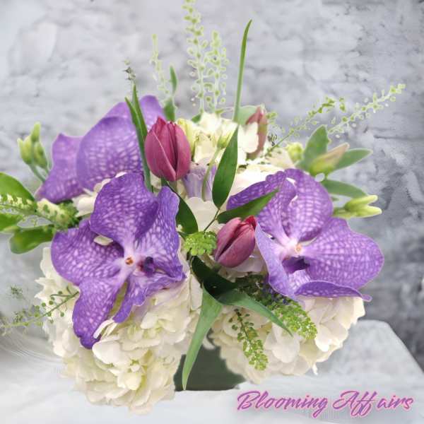 Purple orchids and white hydrangeas in a bouquet