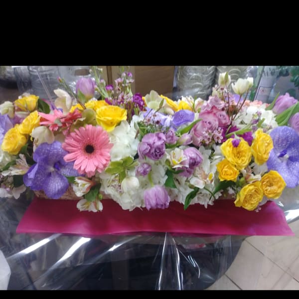 Mixed bouquet with yellow roses, pink gerbera daisies, and purple blooms