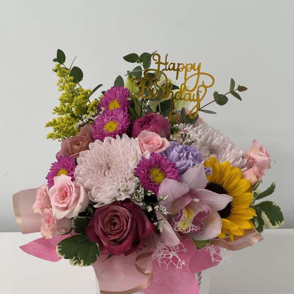 Mixed bouquet in a white hatbox with a gold Happy Birthday topper