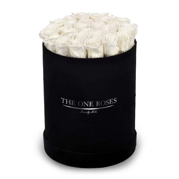 White roses arranged in a black round box
