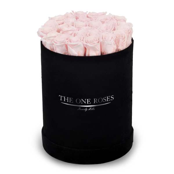 Pink roses arranged in a black round box
