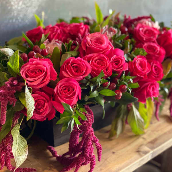 Pink rose arrangement in a black rectangular container