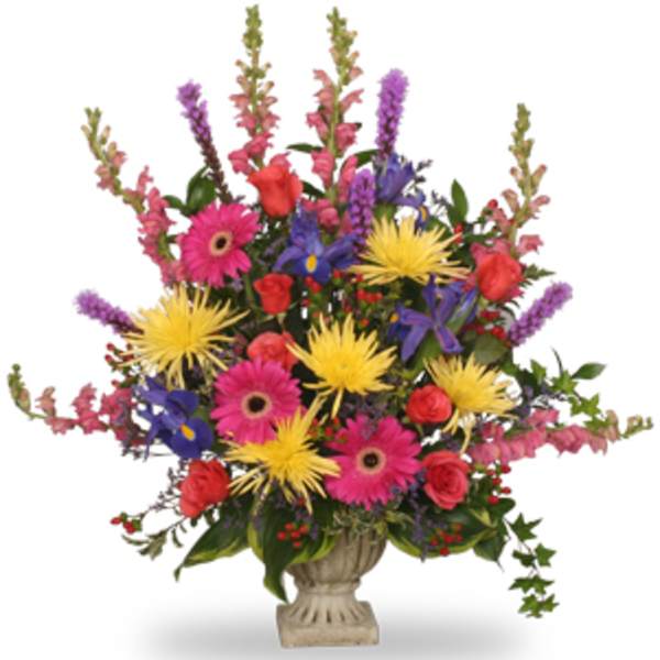 Colorful mixed flower arrangement in a stone urn vase
