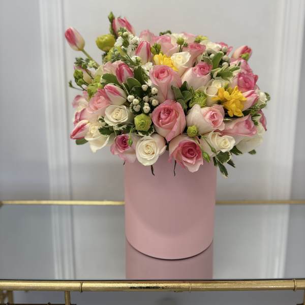 Pink and white rose bouquet in a pink cylindrical box