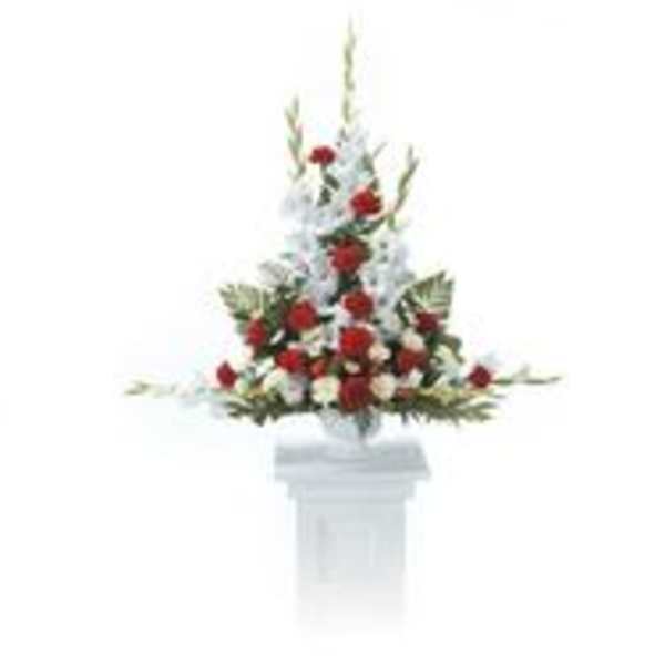 Red and white floral arrangement on a white pedestal
