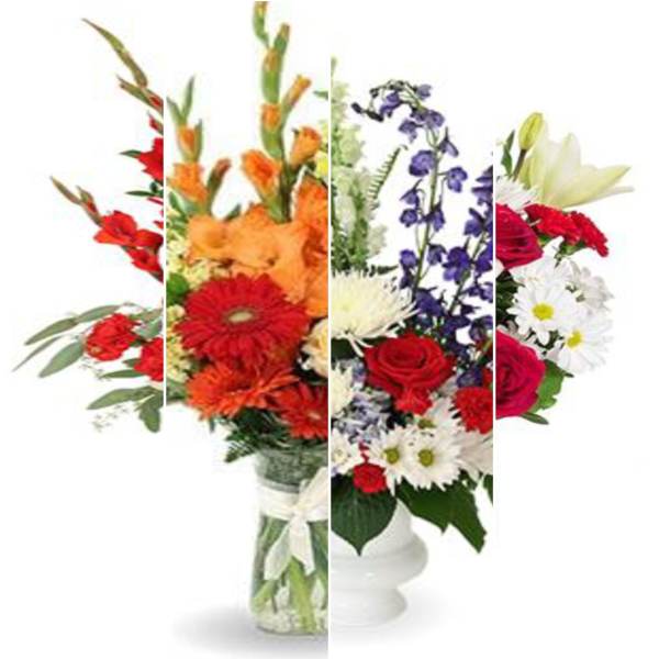 Mixed bouquet of red, orange, purple, and white flowers in a glass vase