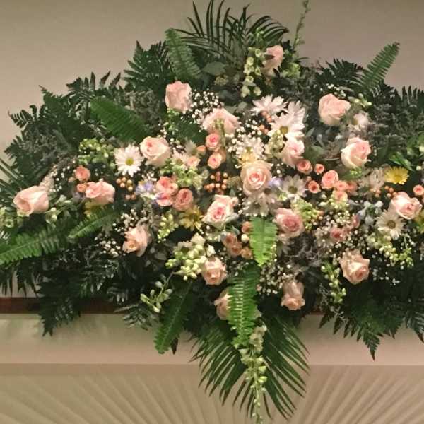 Large pink rose and daisy floral spray with greenery