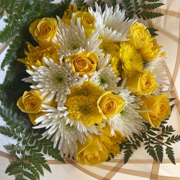 Yellow roses and white chrysanthemums in wrapped bouquet