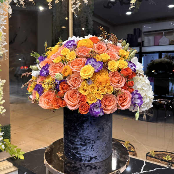 Large mixed bouquet of roses in a black velvet box