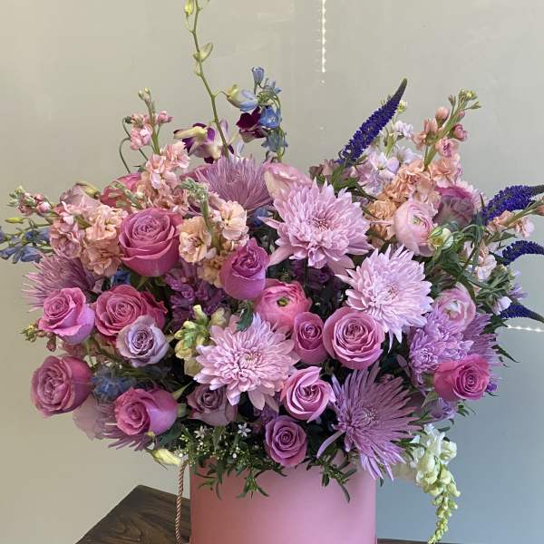 Pink and lavender bouquet in a round pink box