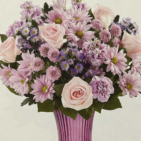 Pink and lavender bouquet in a ribbed magenta vase