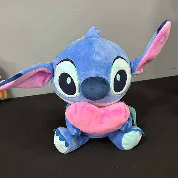 Blue and pink plush character toy with large ears and a heart