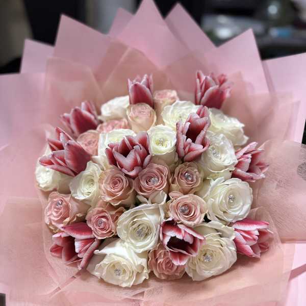 Pink and white rose bouquet with red-and-white tulips wrapped in pink paper