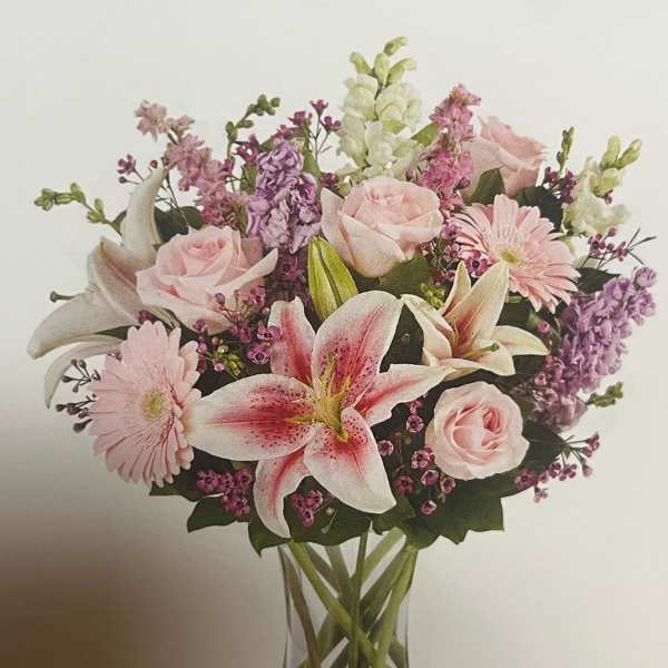 Pink and white mixed bouquet in a clear glass vase