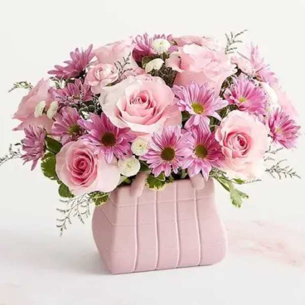 Pink roses and daisy-like flowers in a pink vase
