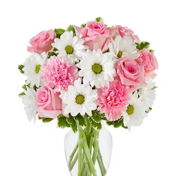 Pink roses and carnations with white daisies in a clear vase