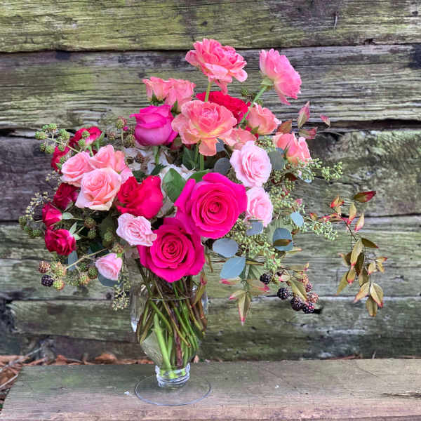 Pink and hot pink roses in a clear glass vase
